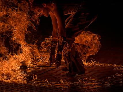 male fire dancer holding two torches surrounded by fire, man dancing fire HD wallpaper