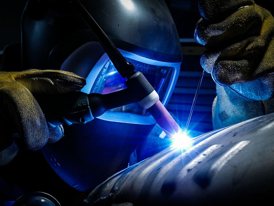 person welding gray metal equipment, man welding steel, industrial