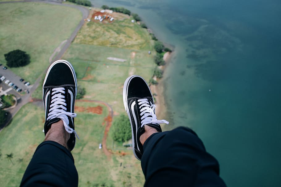 person wearing blue-and-white VANS low-top sneakers with aerial view of body of water, aerial view of person wearing black Vans low-top shoes HD wallpaper