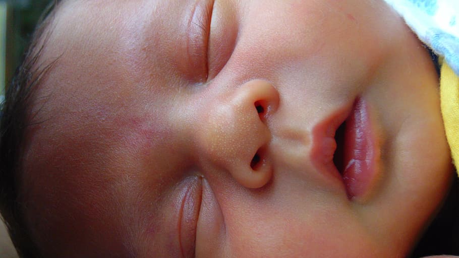 closeup photo of baby's face, sleeping, boy, young, resting, human
