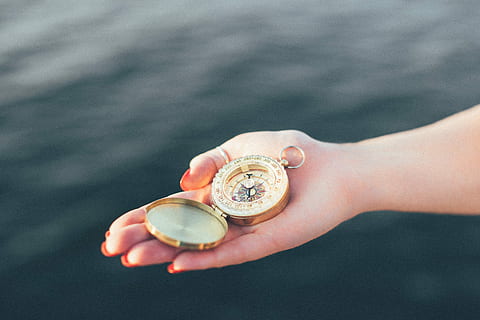 person holding round gold pocket watch on focus photo, compass HD wallpaper
