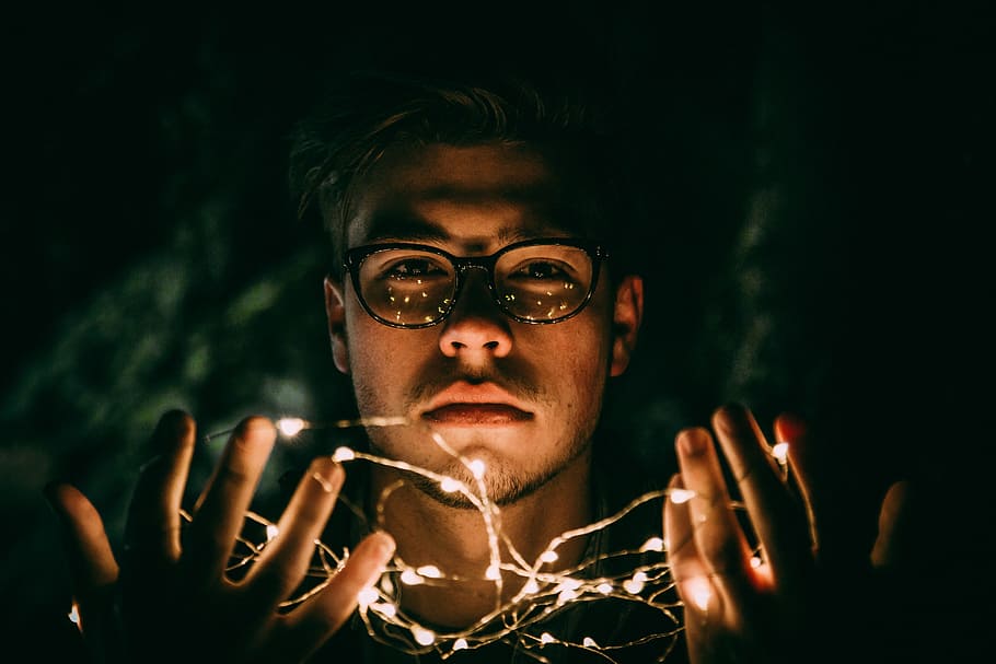 man wearing black eyeglasses, man with string lights on his hands low light photography during nighttime, HD wallpaper