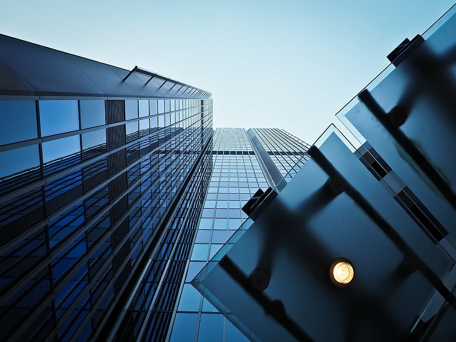low angle photography of curtain wall high rise building under blue sky HD wallpaper