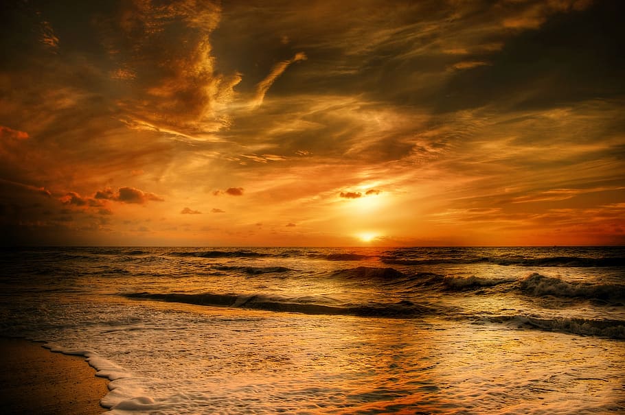 sea against yellow sunlight under grey clouds, sunset, denmark HD wallpaper