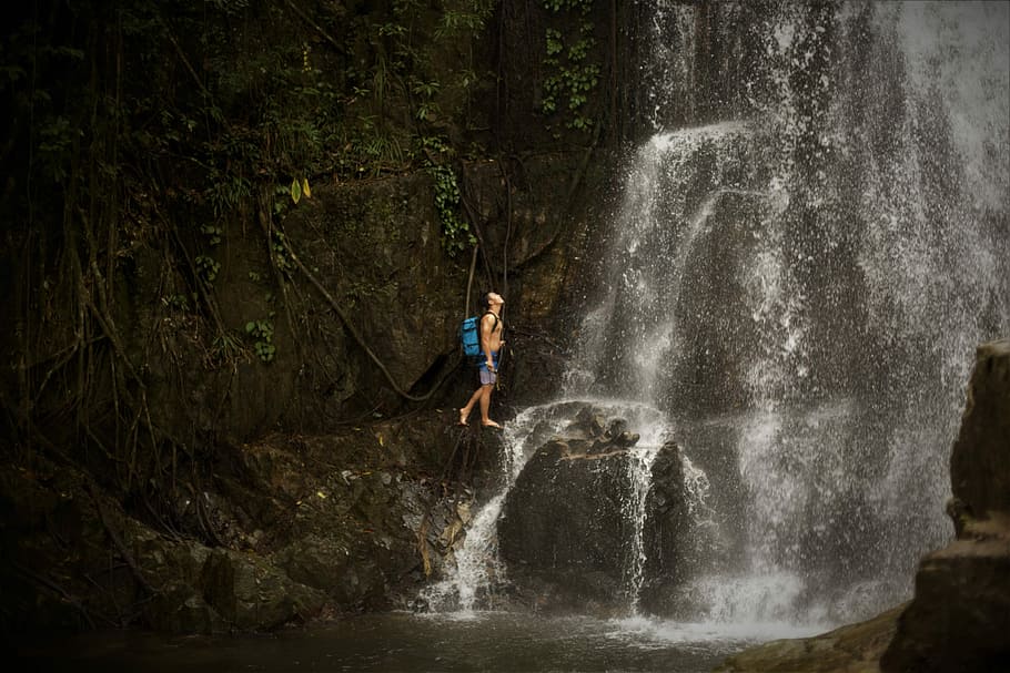 Lost in Chreav Waterfall, man walking under waterfal, mountain HD wallpaper