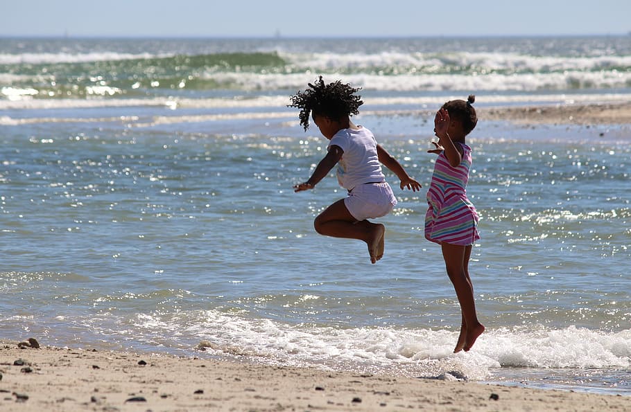 two child hopping near seashore, children, jump, south africa