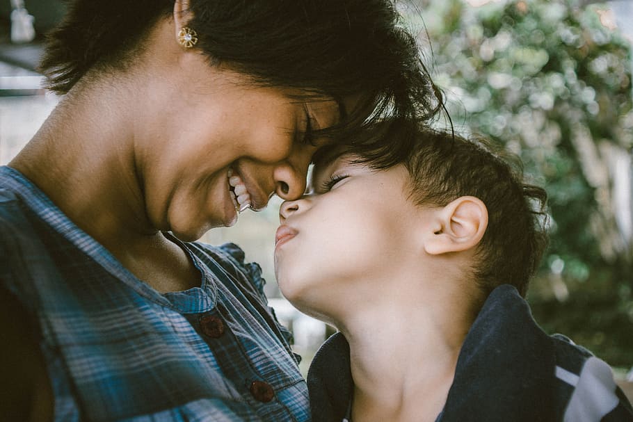 selective focus photography of woman and boy, woman and boy sticking their nose to each other HD wallpaper