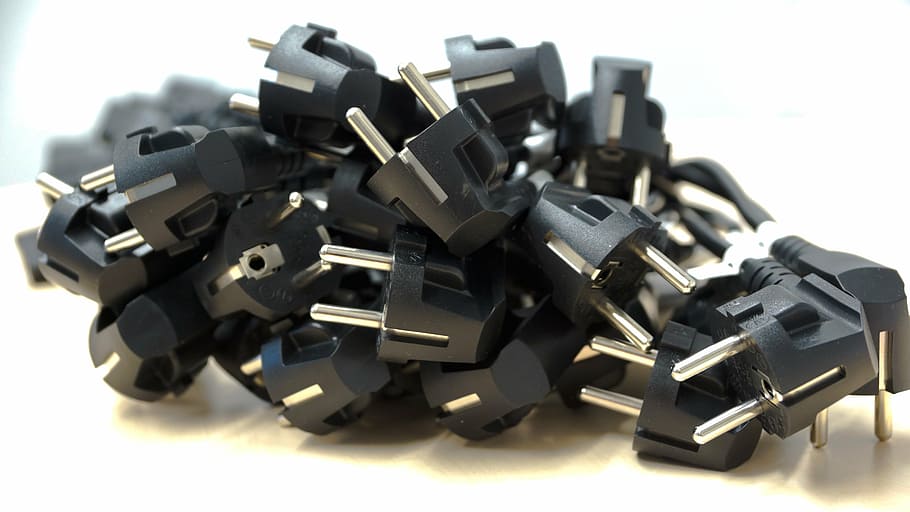 black power plugs piled and placed on beige surface, round HD wallpaper