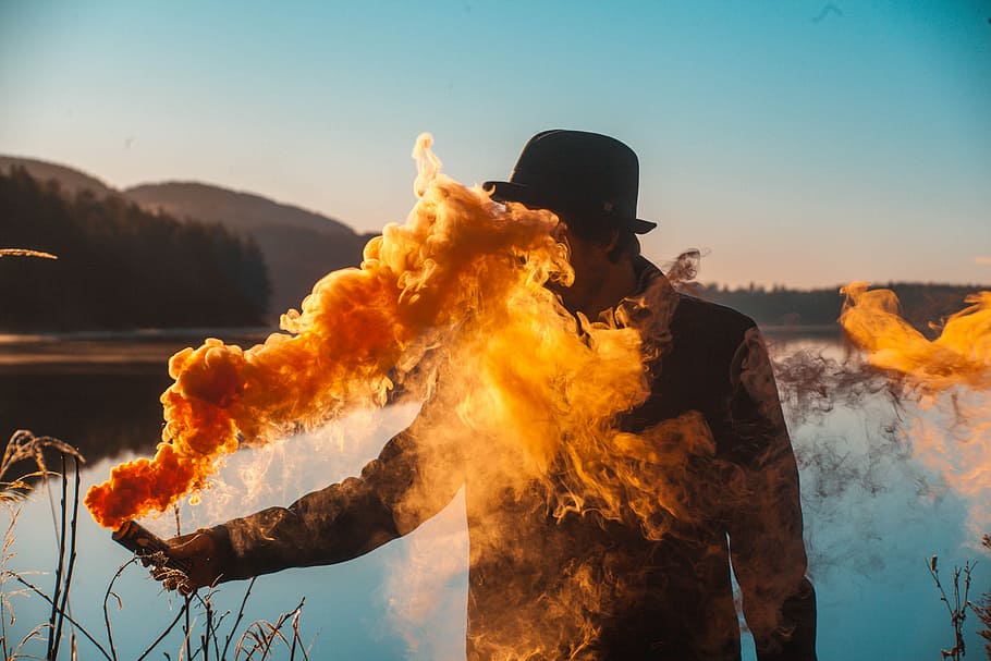 man holding flare, man holding pipe with smoke dispersing towards his face, HD wallpaper