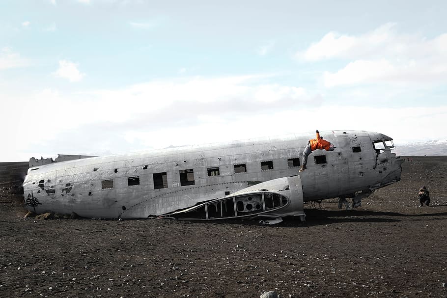 person doing back flip on wrecked plane, human juming on wrecked aircraft