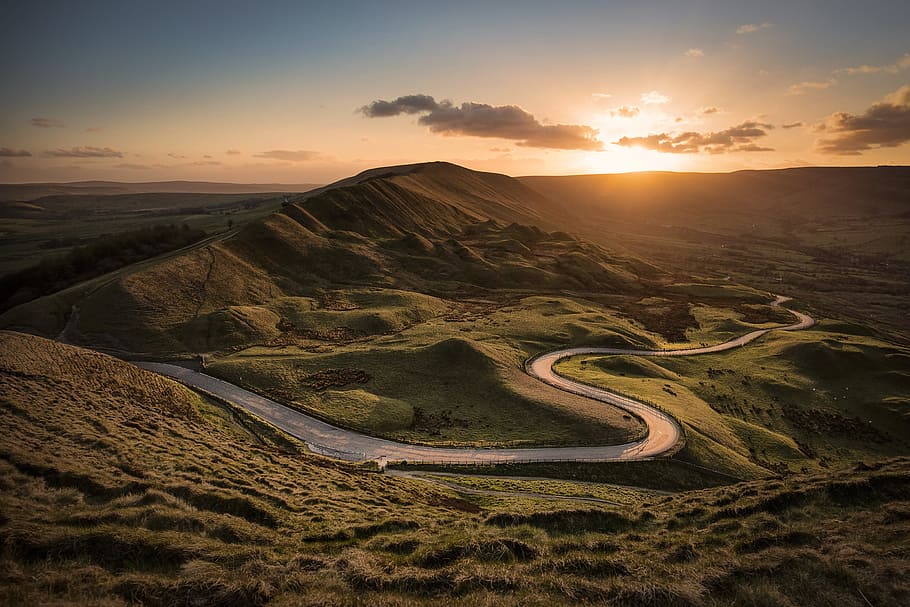 landscape photography of road between hills during golden hour HD wallpaper