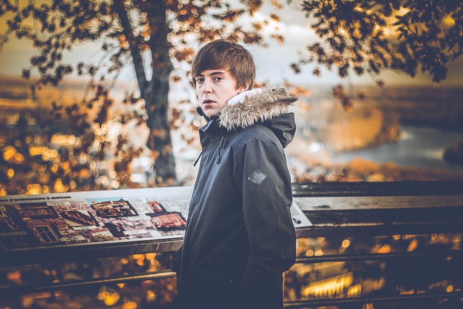 man standing beside railing, male, boy, tree, woodland, one person HD wallpaper