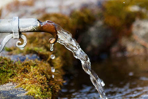 selective focus photography of water pouring from pipe to body of water HD wallpaper