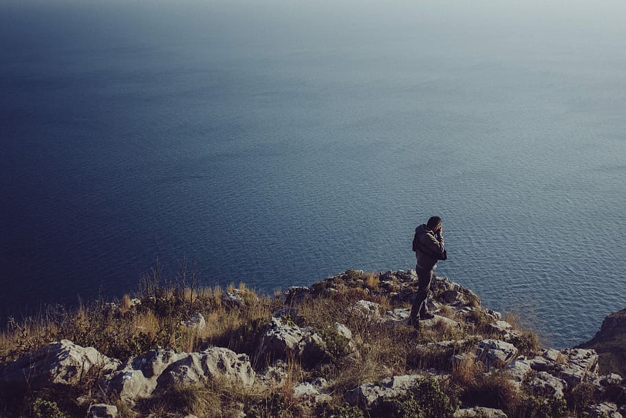 photo of man wearing jacket near body of water, blue, brown, grass HD wallpaper