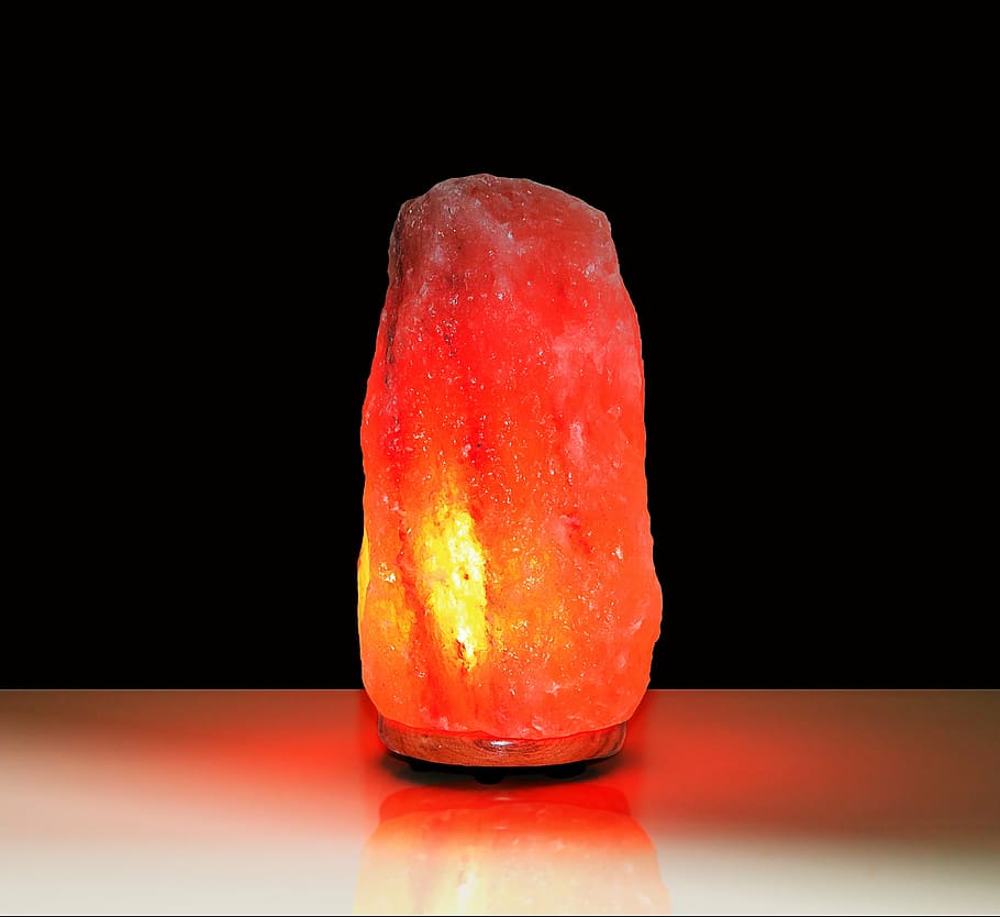 orange salt lamp on white surface, himalayan salt, rock salt