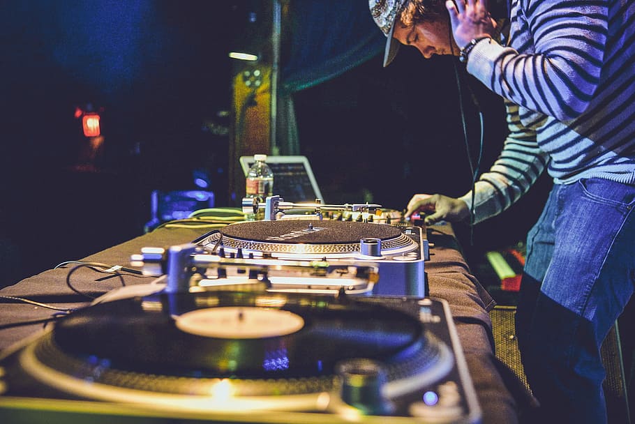 man setting DJ controller, people, guy, music, edm, artist, deejay