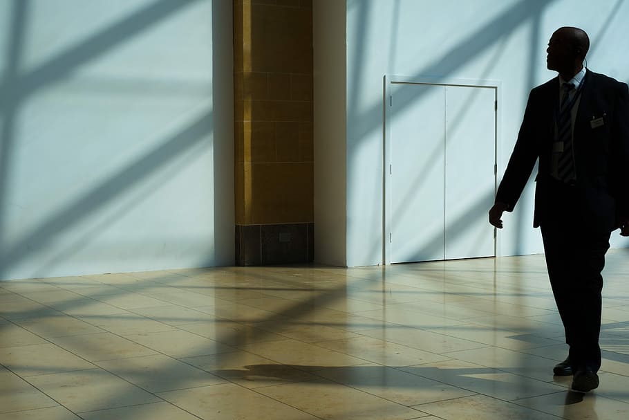 man walking on hallway, man walking on pathway, building, interior HD wallpaper