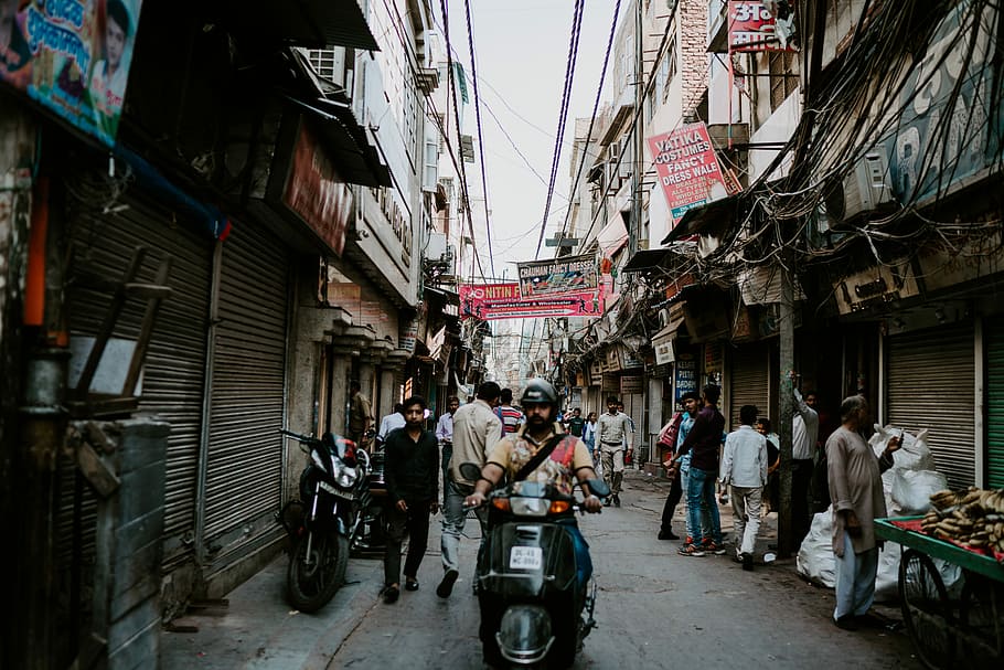 people in alley between buildings, man riding motorcycle near market, HD wallpaper