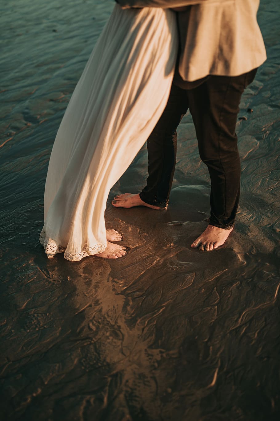 man and woman standing shallow body of water, engagement photography of man and woman barefooted on mud HD wallpaper