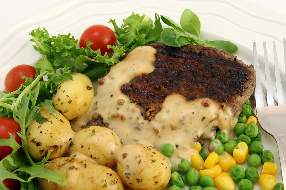 cooked dish in white ceramic plate beside silver-colored fork HD wallpaper