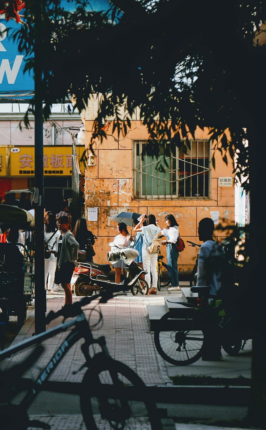 people on the street, people near two bicycles, city, building HD wallpaper