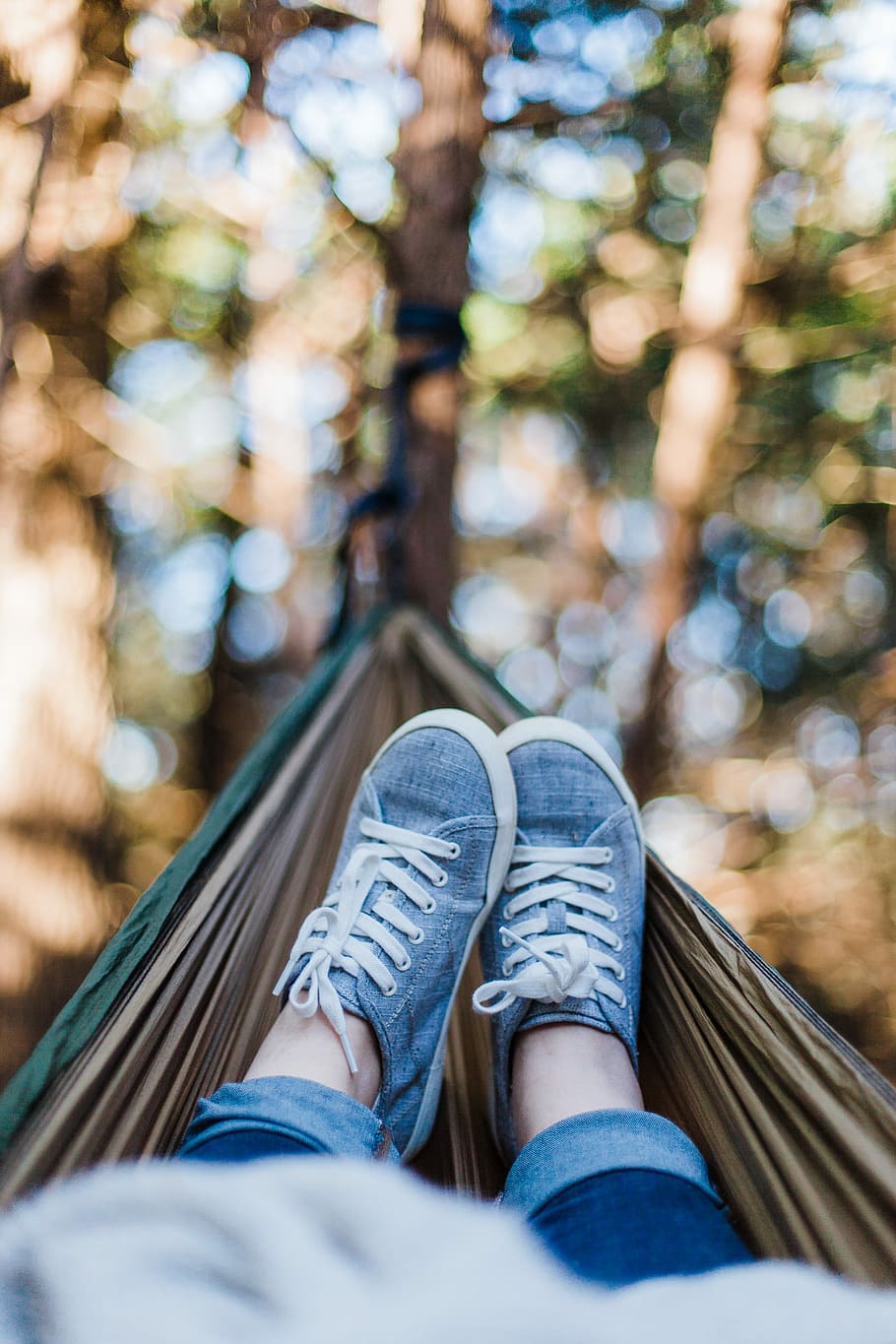 person laying down on brown hammock during daytime, selective focus photography of person on hammock HD wallpaper