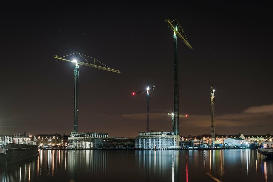 tower cranes near body of water, view, city, night, architecture HD wallpaper