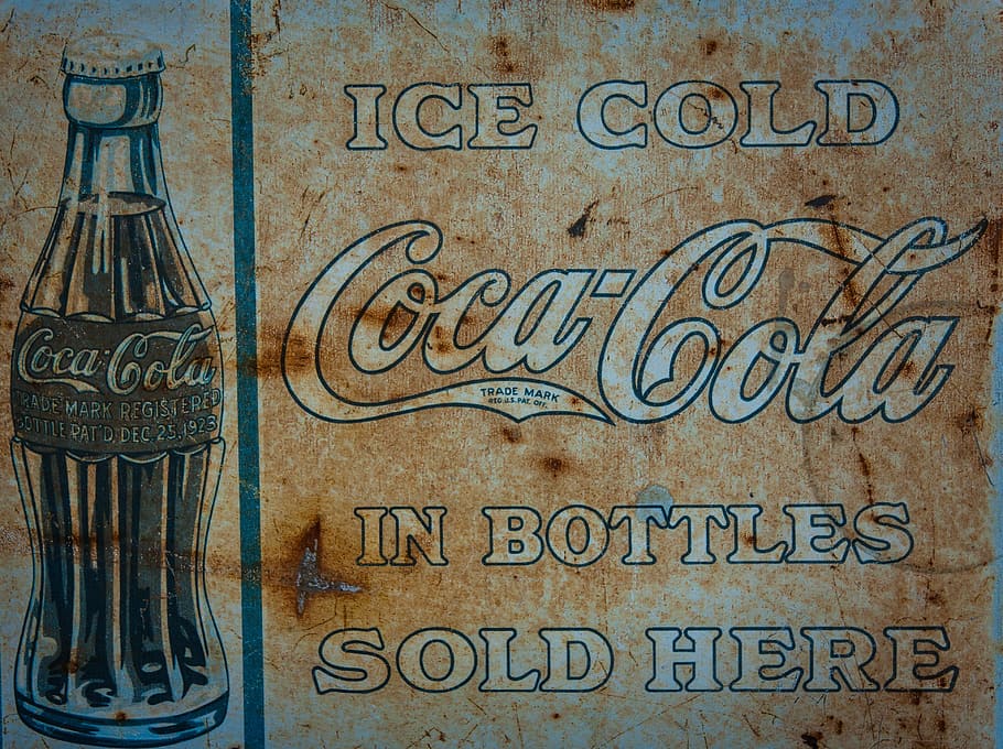 brown and white Ice Cold Coca-Cola In Bottles Sold Here signage