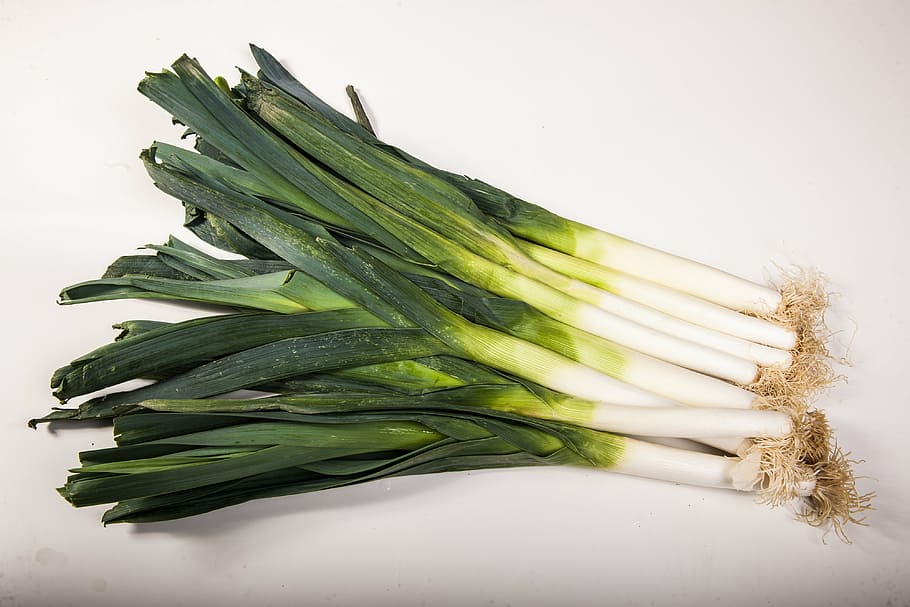 green onions on white surface, vegetables, see, power, leeks HD wallpaper