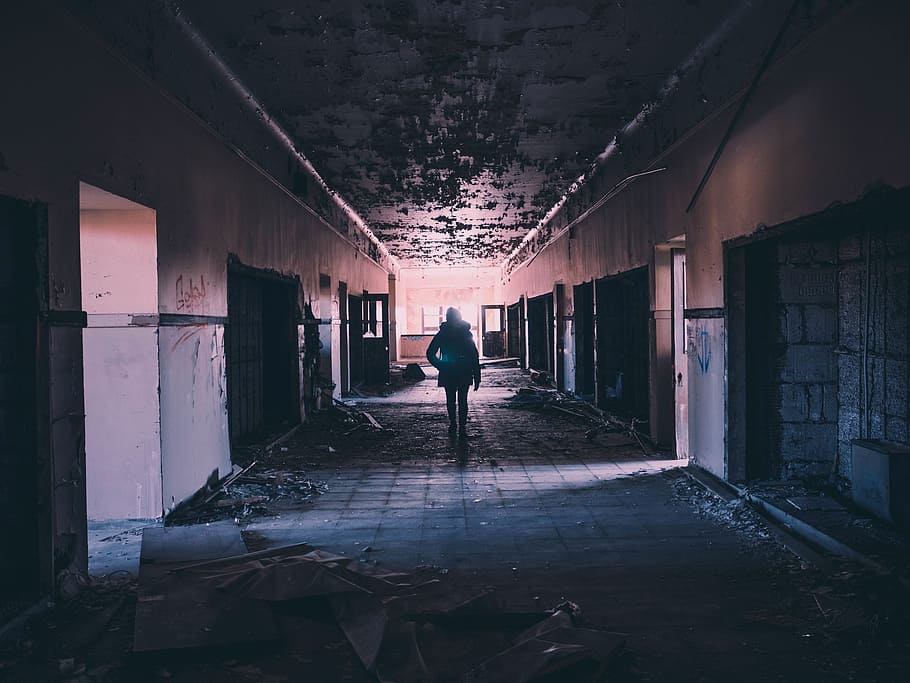 man walking on ceramic floor building, hallway, abandoned, damaged