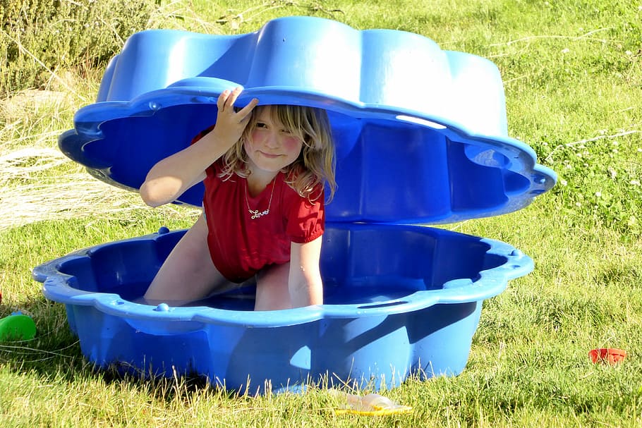 girl inside blue sandbox, shell, play, hide, search, summer games