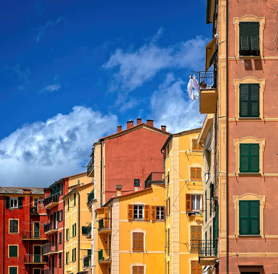 yellow and brown concrete building under cloudy sky, concrete buildings under blue cloudy sky HD wallpaper