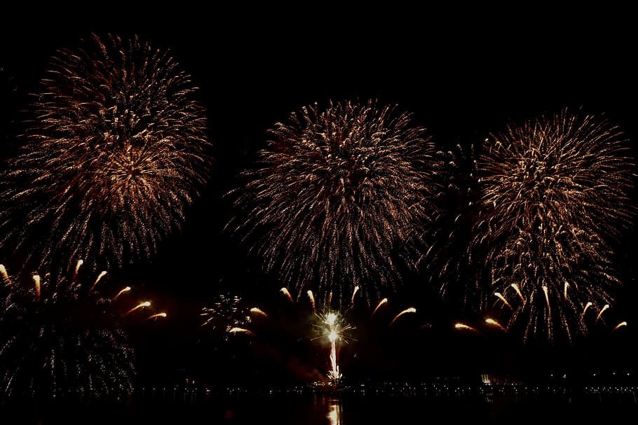 fireworks display during nighttime, person taking photo of fireworks display during night HD wallpaper