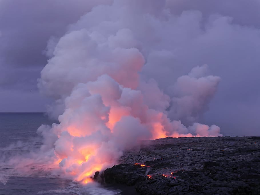 hill burned near ocean under white sky, lava on sea with white smoke under grey skly HD wallpaper