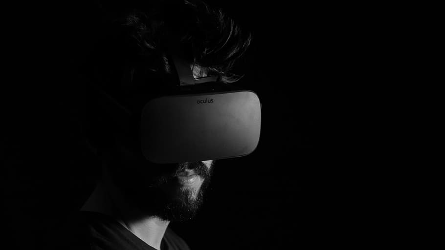 Video game visor, grayscale photography of man using virtual reality headset