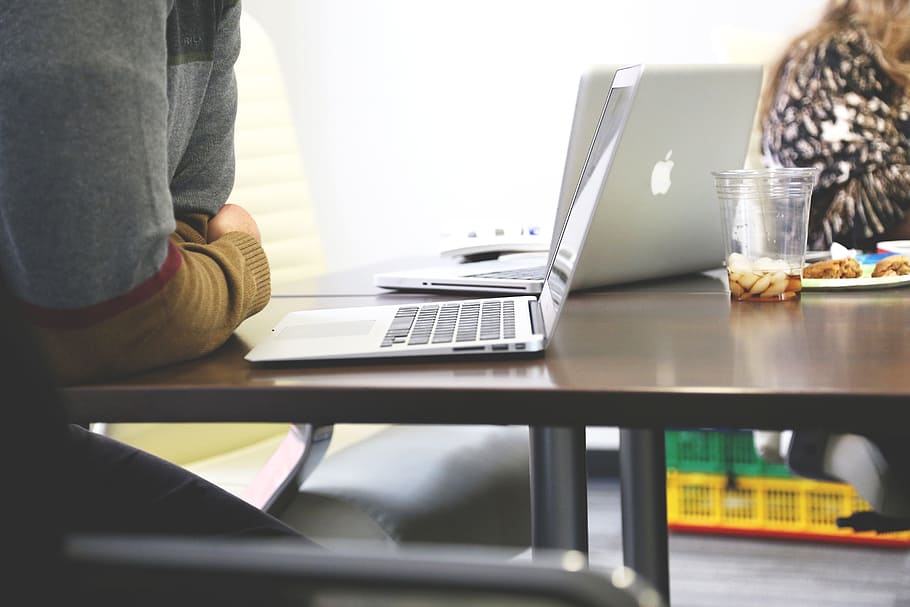 person leaning on table using MacBook, startup, start-up, notebooks HD wallpaper