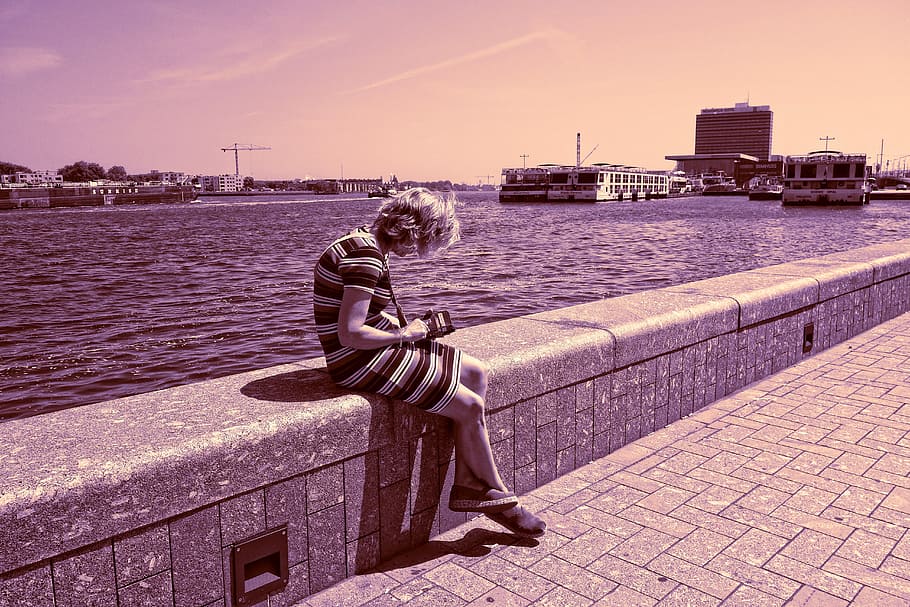 person, woman, sitting, checking phone, wall, water, harbour, HD wallpaper