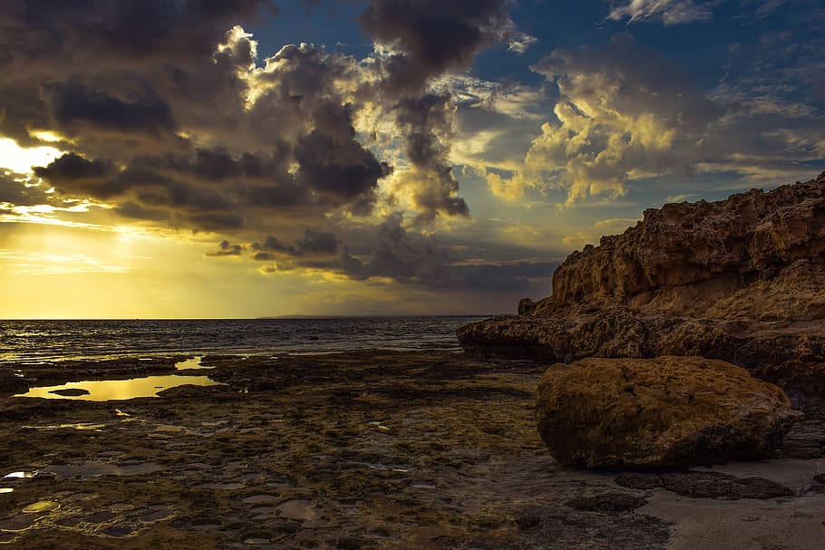 brown mountain near seashore under gray sky, clouds, dramatic HD wallpaper
