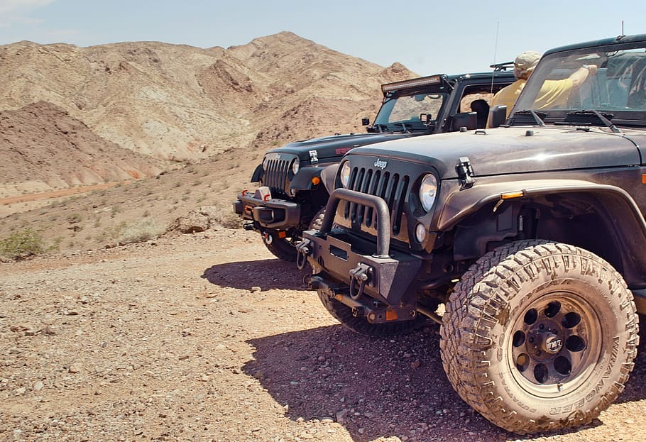 two black Jeep Wrangler SUVs on dirt road at daytime, transportation HD wallpaper