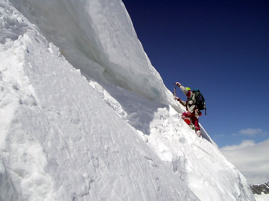 man climbing on snow coated mountain during daytime, Mountaineering
