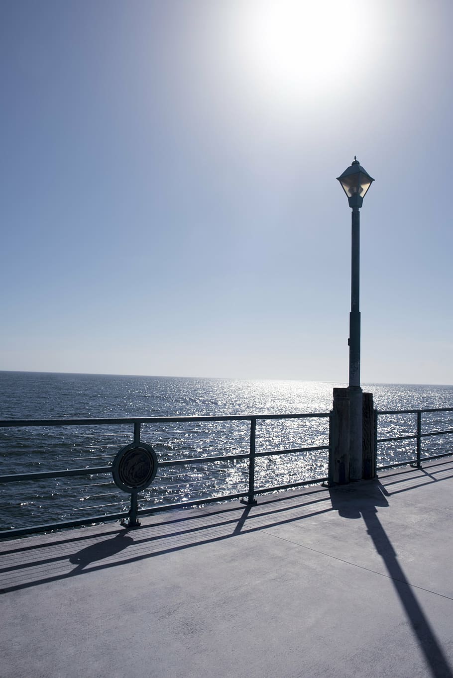 horizon, beach, pier, post, glare, water, sea, ocean, sky, landscape HD wallpaper