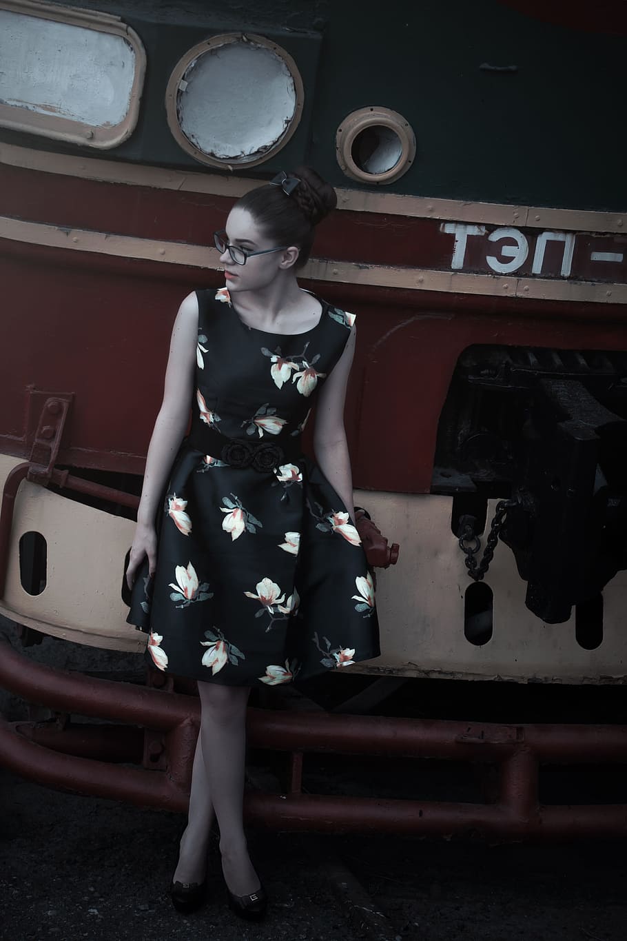 woman wearing black and white floral sleeveless dress, girl at the station