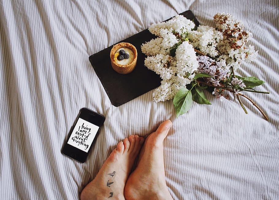 person's feet near white petal flowers, bed, sheet, desserts HD wallpaper