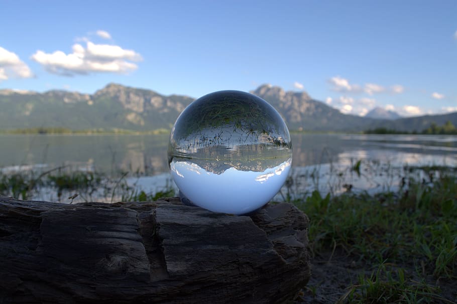 white glass ball on brown wood, globe image, alpine, panorama