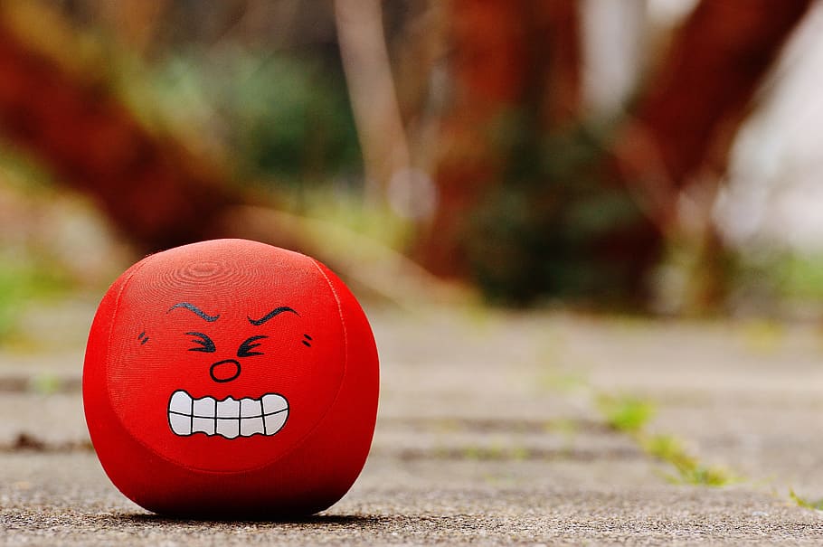 red emoji toy on gray pavement, smiley, rage, evil, sour, funny HD wallpaper