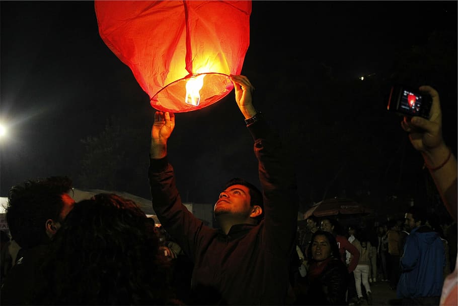 person holding paper air lantern, photography, man, fire, dark HD wallpaper