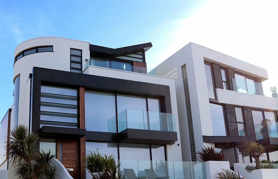 white and brown concrete house under blue sky during daytime HD wallpaper