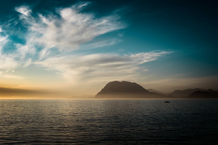 body of water across mountain, silhouette of mountain under cloudy sky HD wallpaper