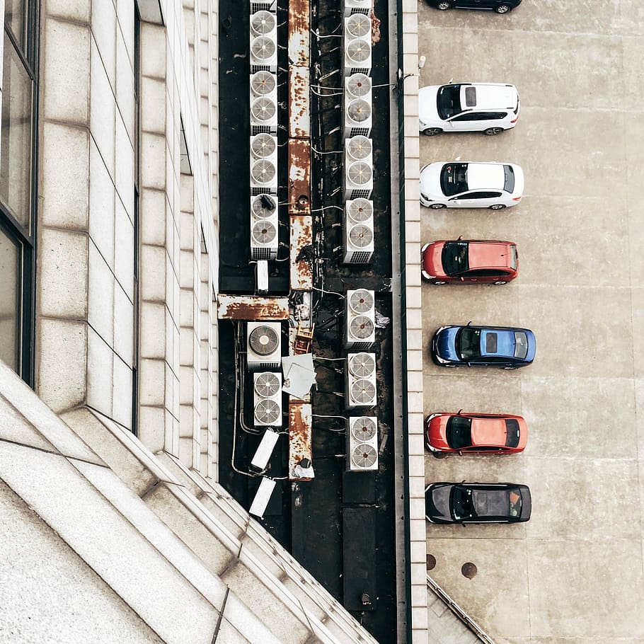 seven cars parked in front of white building top view photography during daytime HD wallpaper