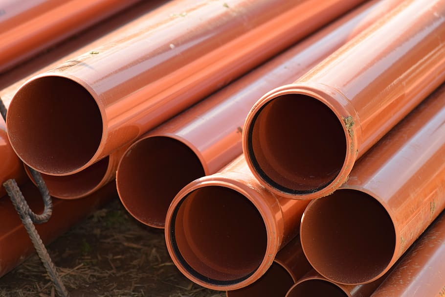 pile of brown PVC pipes, sewer pipes, tube, construction material